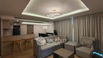 Modern living room with stylish lighting and cozy seating area in open-plan layout.