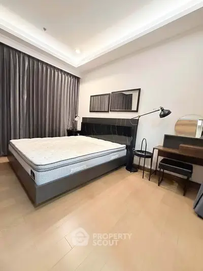 Modern bedroom with stylish decor and ample natural light, featuring a comfortable bed and elegant furnishings.