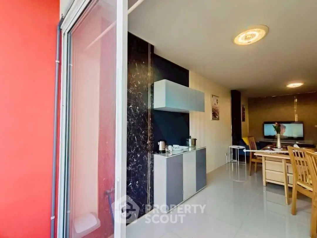 Modern open-layout kitchen and dining area with sleek design and natural light.