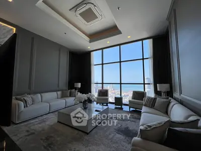 Luxurious high-rise living room with panoramic city views and elegant furnishings.
