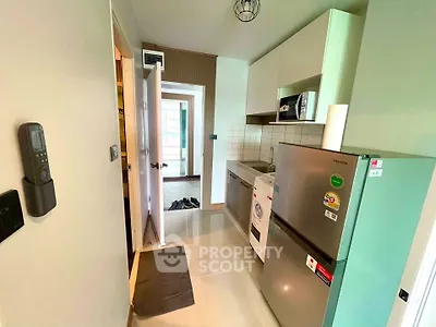 Modern kitchen with sleek appliances and open layout in a stylish apartment.