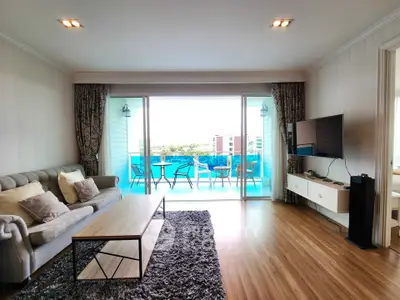 Spacious living room with modern decor and large balcony offering stunning views