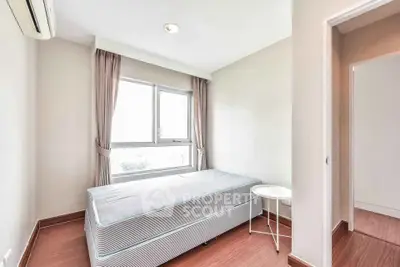Bright and cozy bedroom with large window and minimalist decor
