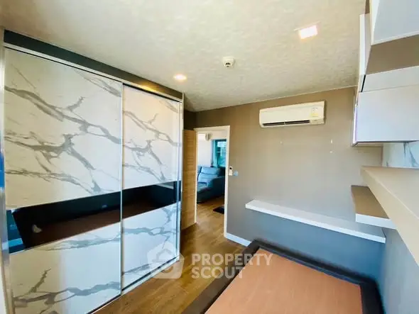 Modern bedroom with stylish wardrobe and air conditioning unit