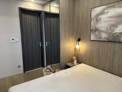 Modern bedroom with stylish decor and mirrored closet doors