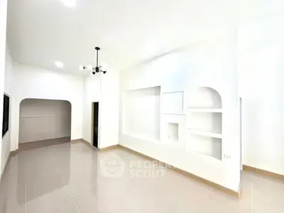 Spacious modern living room with elegant lighting and sleek tile flooring