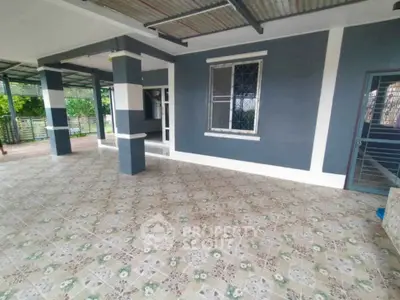 Spacious covered patio with tiled flooring and modern exterior design.