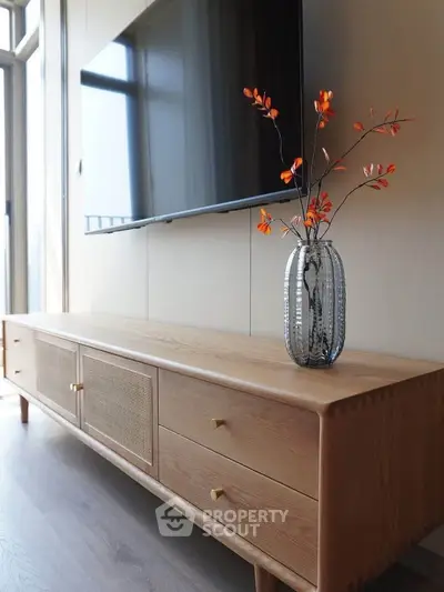 Modern living room with sleek TV and stylish wooden console