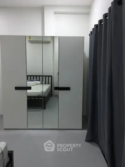 Modern bedroom with mirrored wardrobe and minimalist design