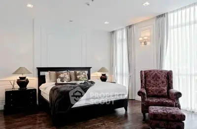 Luxurious bedroom with elegant decor and large windows for natural light.