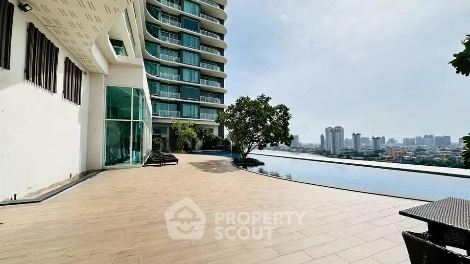Luxurious high-rise building with stunning infinity pool and city skyline view.