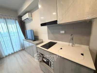 Modern kitchen with sleek cabinetry and integrated appliances in a bright apartment