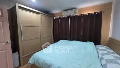 Cozy bedroom with large wardrobe and air conditioning, perfect for restful nights.
