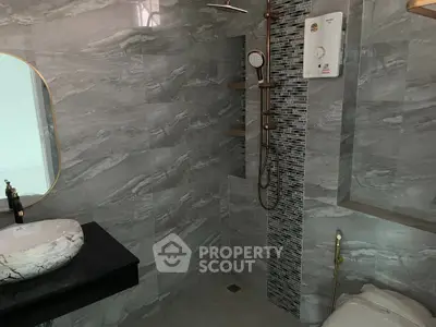 Modern bathroom with sleek gray tiles and stylish fixtures