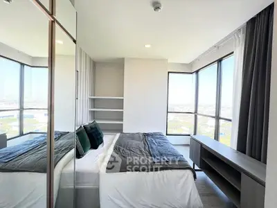 Modern bedroom with panoramic city views and sleek furnishings