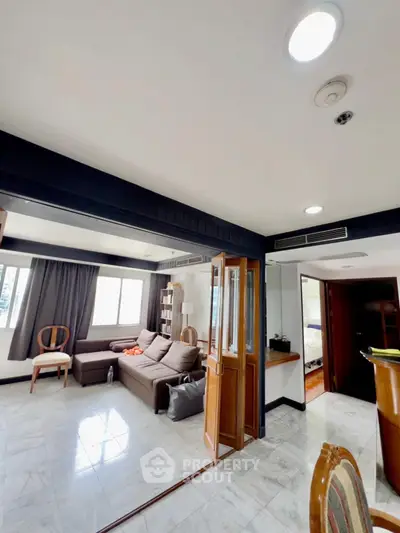 Spacious living room with modern decor and natural light