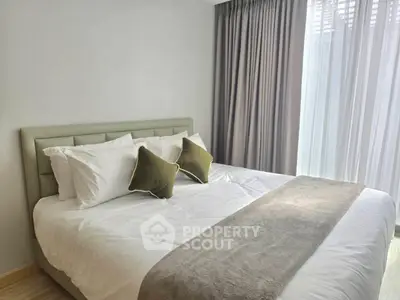 Modern bedroom with elegant decor and large window for natural light.