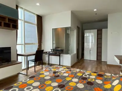 Modern studio apartment with large windows and stylish decor in a vibrant city location.