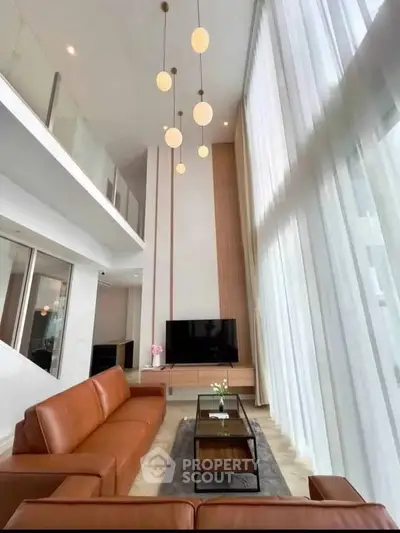 Luxurious modern living room with high ceilings and elegant decor