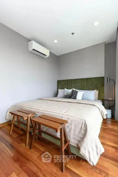 Modern bedroom with wooden flooring and stylish decor