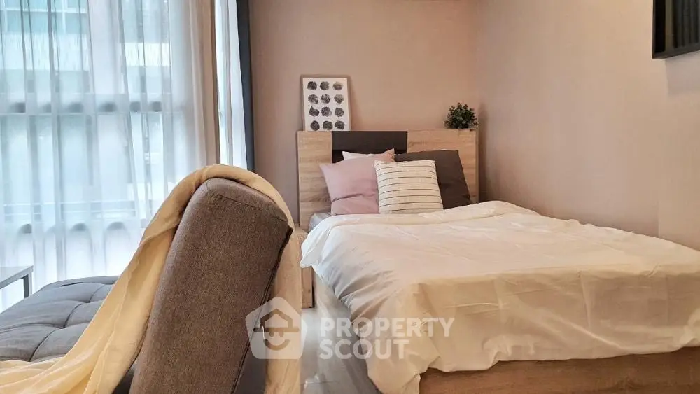 Cozy bedroom with modern decor and natural light in urban apartment