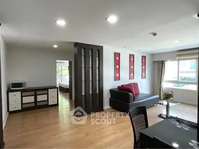 Spacious living room with modern decor and large windows offering natural light.