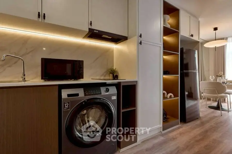 Modern kitchen with built-in appliances and elegant dining area