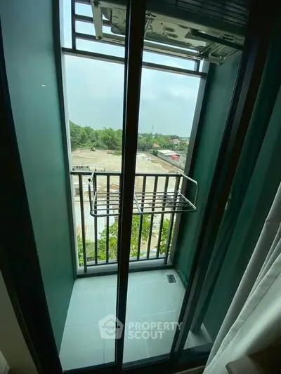 Compact balcony with drying rack and scenic view in modern apartment