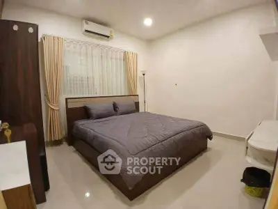 Modern bedroom with cozy bed, air conditioning, and elegant curtains in a stylish home.