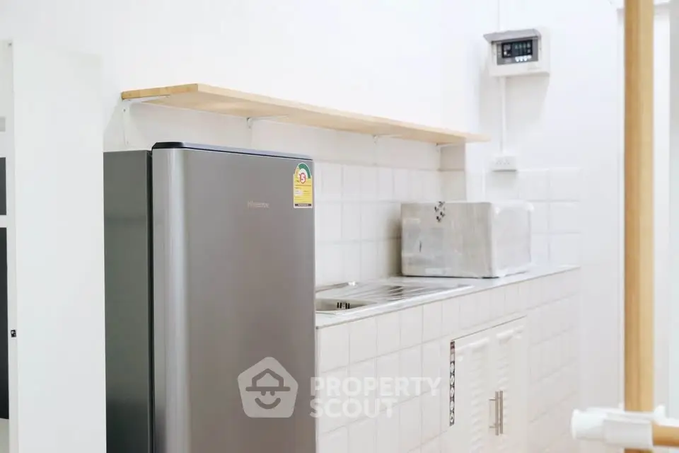 Modern kitchen with sleek fridge and stainless steel appliances