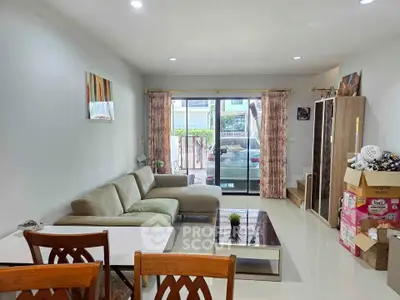 Spacious living room with modern decor and large windows for natural light.