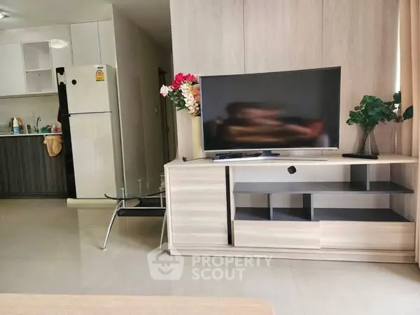 Modern living room with sleek TV stand and open kitchen layout