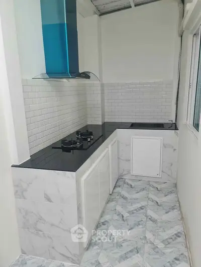 Modern kitchen with sleek marble countertops and gas stove