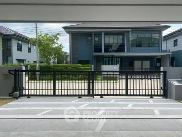 Modern residential building with sleek design and gated entrance
