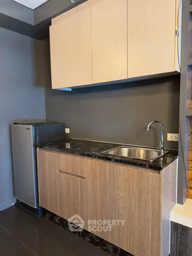 Modern kitchen with sleek cabinetry and stainless steel fridge