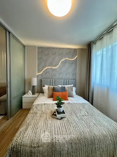 Modern bedroom with stylish decor and natural light, featuring a cozy bed and elegant design elements.