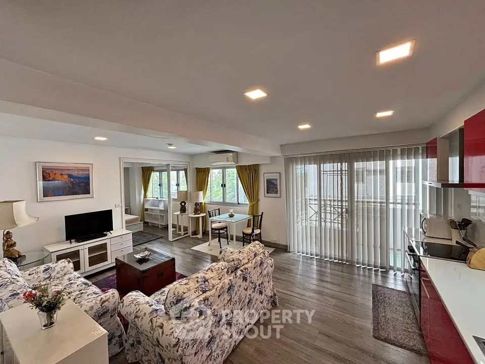Spacious living room with modern decor and large windows offering natural light.