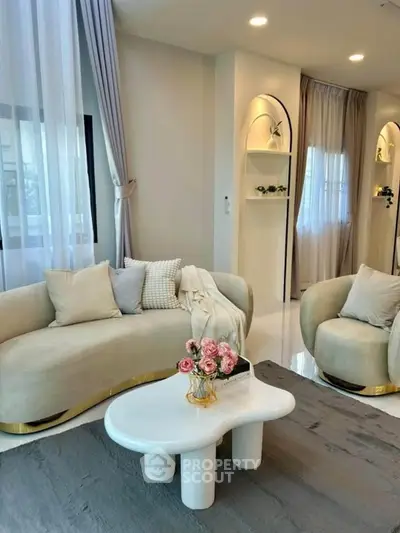 Elegant living room with modern furniture and stylish decor, featuring plush sofas and a chic coffee table.