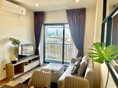Modern living room with city view, stylish decor, and balcony access in urban apartment.