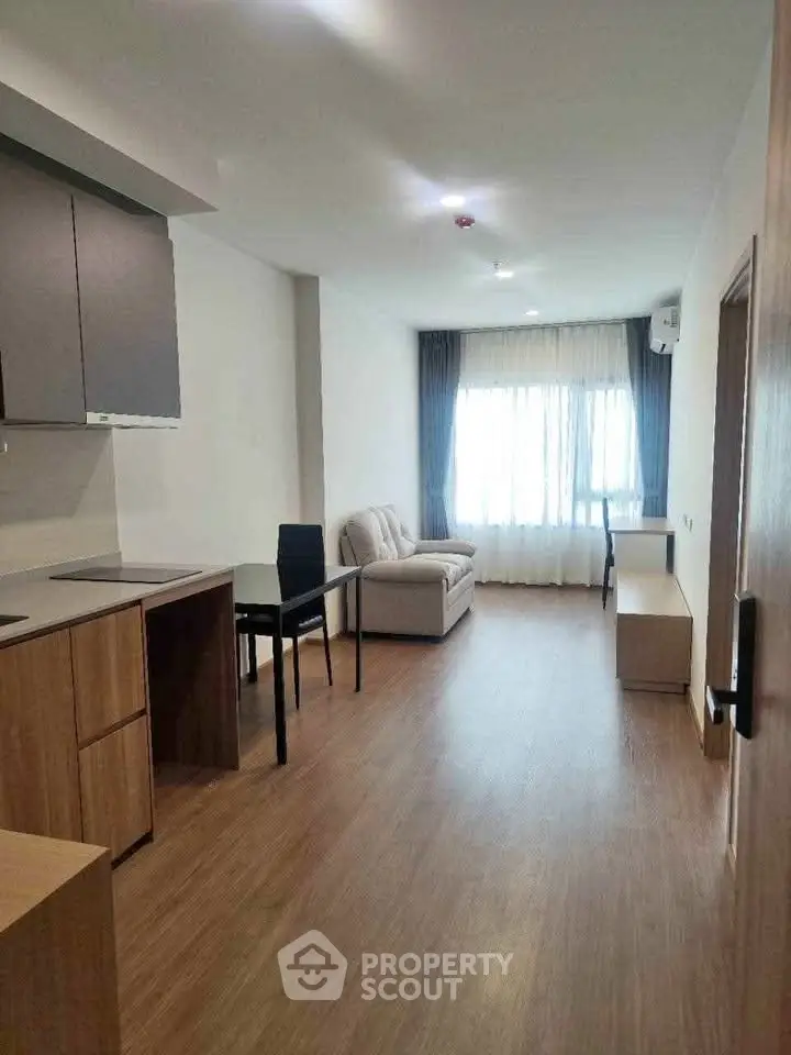 Modern living room with sleek furniture and natural light, perfect for urban living.