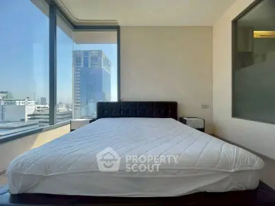 Luxurious bedroom with panoramic city views and modern design in high-rise apartment.