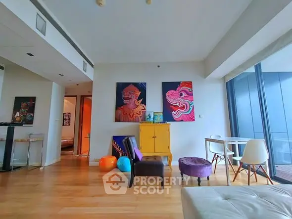 Modern living room with colorful art and floor-to-ceiling windows