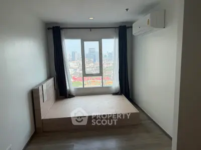 Spacious bedroom with city view and modern air conditioning unit.