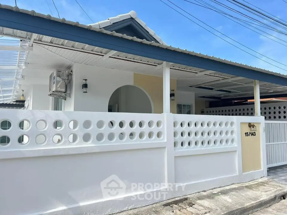 Charming single-story home with unique circular wall design and modern exterior.