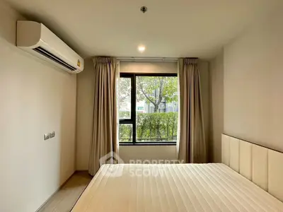 Modern bedroom with large window and air conditioning, offering a serene view of greenery.