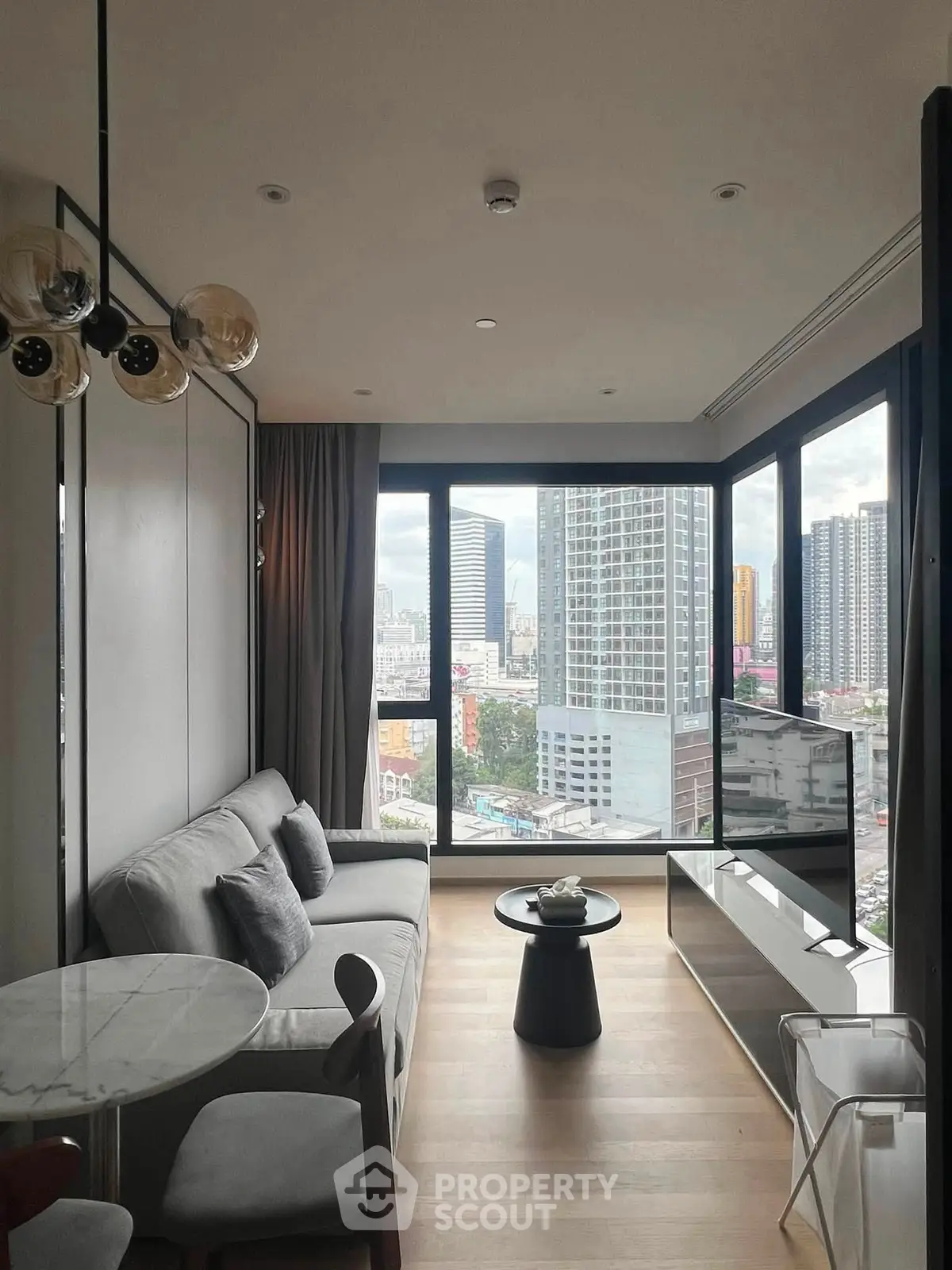 Modern living room with panoramic city view and stylish furnishings