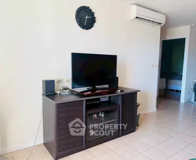 Modern living room with TV, air conditioning, and stylish cabinet
