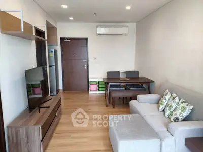 Modern living room with stylish furniture and wooden flooring in a cozy apartment.