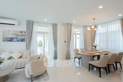 Elegant living and dining area with modern decor and natural light