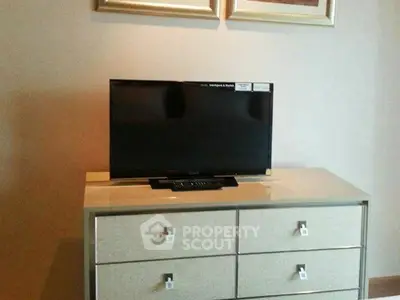 Modern living room with sleek TV on stylish dresser, perfect for contemporary home decor.